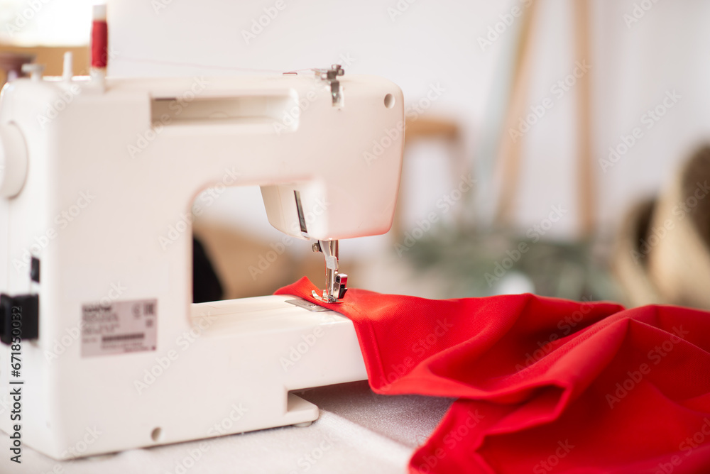 Sewing machine with red cloth closeup. sewing process in the re-stitching phase