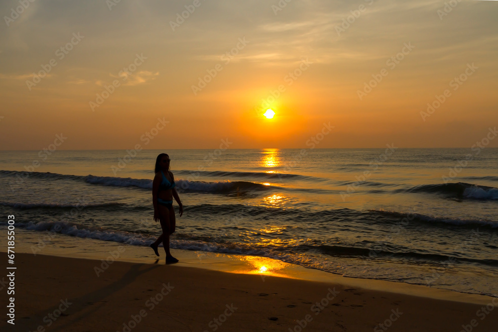 Woman body big with bikini and sunrise on beach