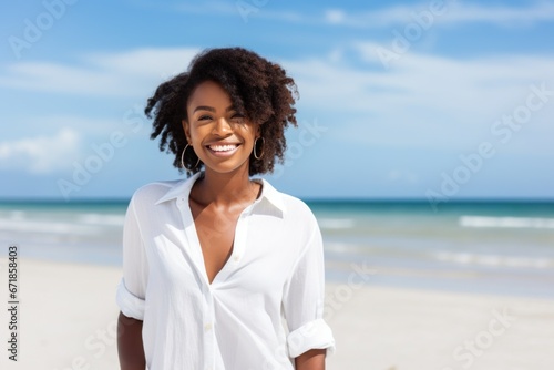 Black woman walking on beach smiling happy
