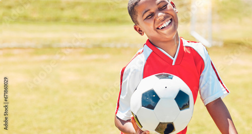 Happy, soccer and child on sport field with soccer ball excited for training, game or competition with smile. Black kid, football and health of young athlete on grass ready to play match for fitness. © Lumeez Ismail/peopleimages.com