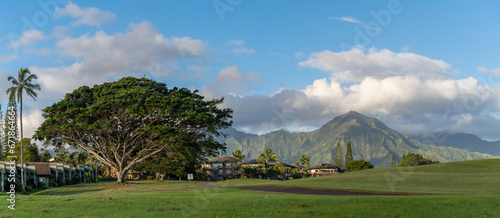 A panorama of the beautiful landscape of a golf course in Princeville with a view of the mountains on the island of Kauai, Hawaii, USA.
 photo