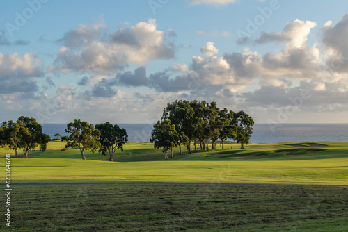 The beautiful landscape of a golf course in Princeville with a view of the sea on the island of Kauai, Hawaii, USA.
 photo