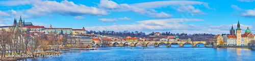 Panorama of deep blue Vltava River and Charles Bridge, Prague, Czechia photo