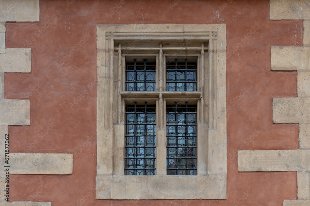 Detail of old window on the wall of an old building with lattice.