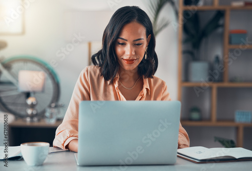 Bilde på lerret Woman working on laptop online, checking emails and planning on the internet while sitting in an office alone at work