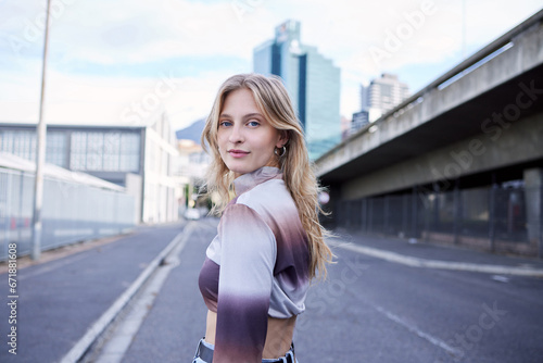Portrait of gen z city girl, natural beauty and standing on asphalt road with confidence, woman empowerment and self love. Skincare, pride or relax young person walking in urban San Francisco street