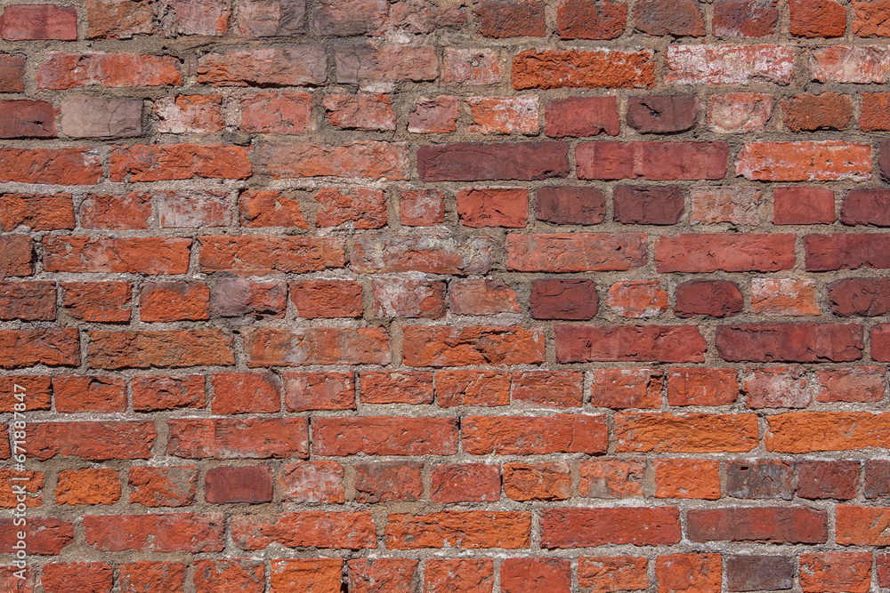 Obraz premium red brick wall in old european city as background