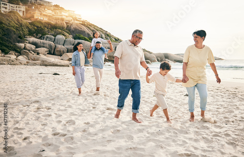 Holding hands, big family and walking at a beach for travel, vacation and fun in nature together. Freedom, parents and children relax with grandparents at the sea on holiday, trip or ocean adventure