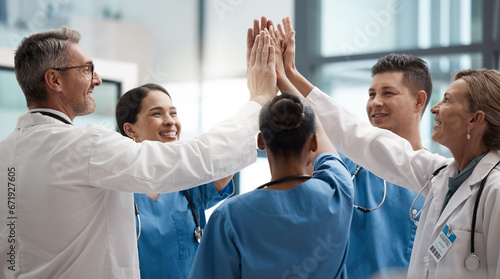 Hands, high five and collaboration with a team of a doctor, nurse and health professional working in the hospital. Teamwork, motivation and support with a medical group at work in a clinic for care