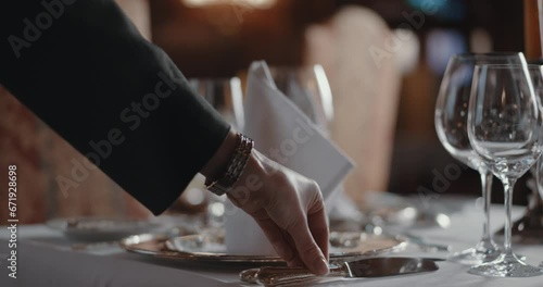 Woman carefully setting an upscale table