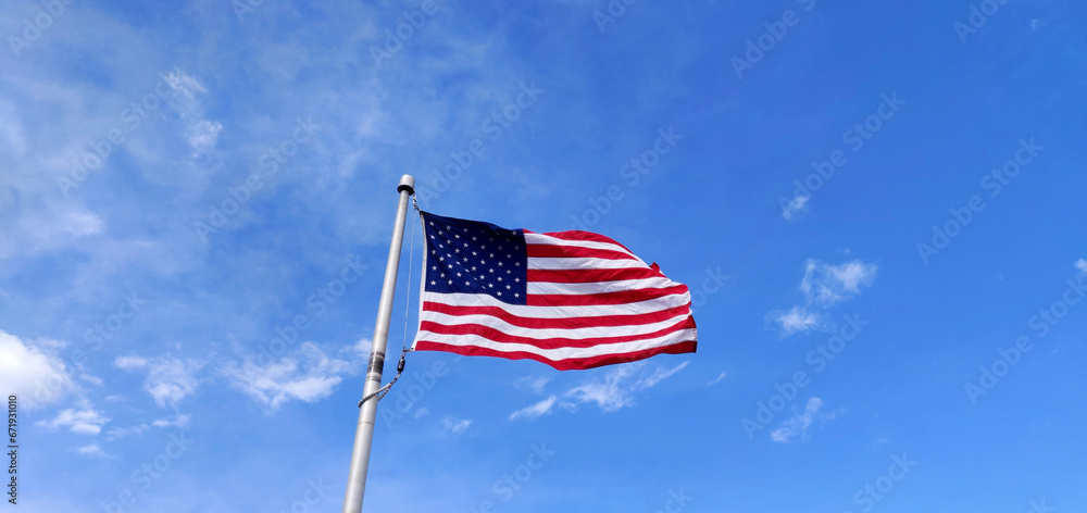 Fototapeta premium US Flag against blue sky