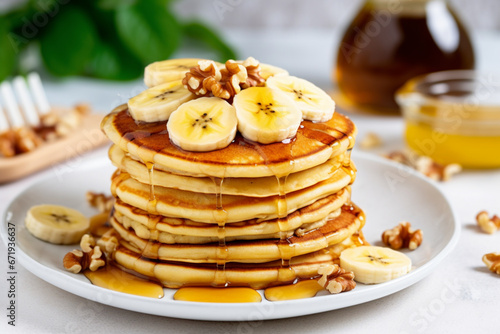 Stack of homemade pancakes for breakfast with banana and walnuts