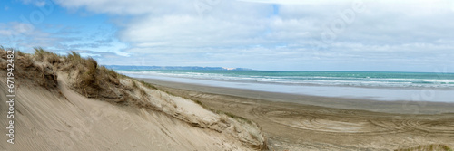 Fototapeta Naklejka Na Ścianę i Meble -  Ninety Mile Beach, New Zealand, with Tire Tracks Leading into the Endless Horizon of Northlands