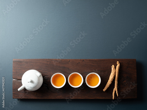 Dried ginseng and hot tea on tea table