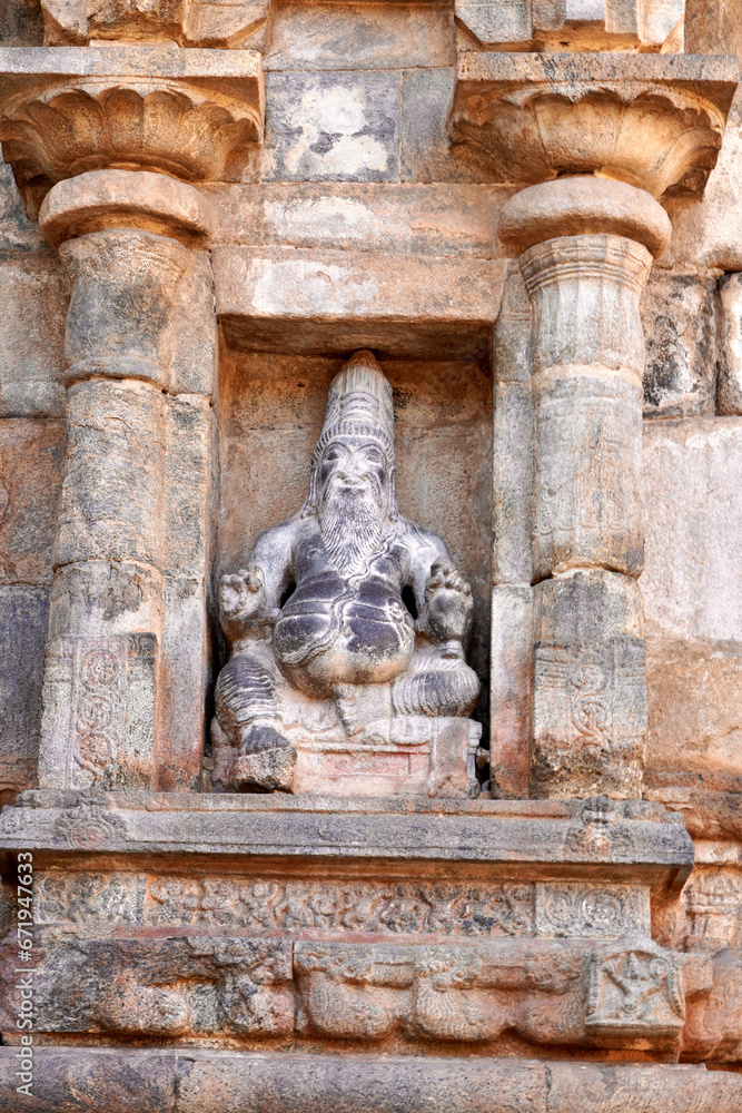 Statue of Hindu God in stone relief Temple wall at Airavatesvara Temple, Darasuram, Kumbakonam, Tamilnadu.