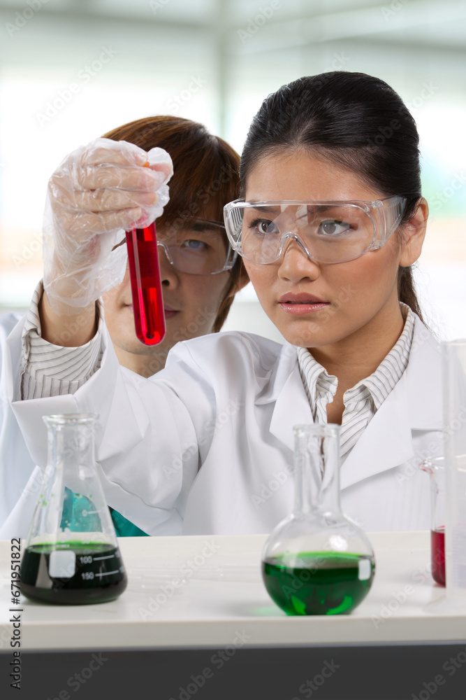 Two scientists analyzing solution. Two scientists analyzing solution.