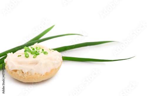 Tasty crouton with cream cheese and green onion on white background