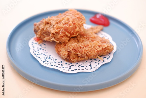 Crispy fried chicken on a plate with sauce, stock photo