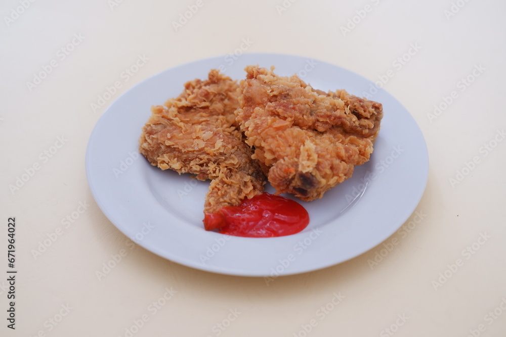 Crispy fried chicken on a plate with sauce, stock photo Crispy fried chicken on a plate with sauce, stock photo