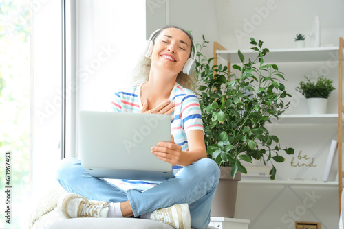 Mature woman with laptop an...