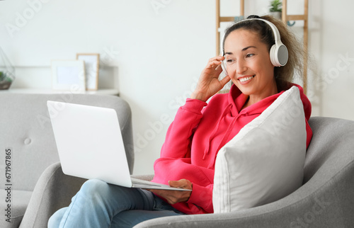 Mature woman with laptop an...