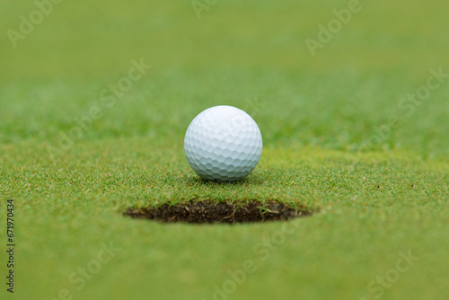 A golf ball and hole