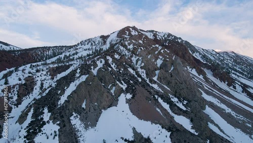 Cinematic aerial shot of snow covered Sierra Nevada mountains in California, USA photo