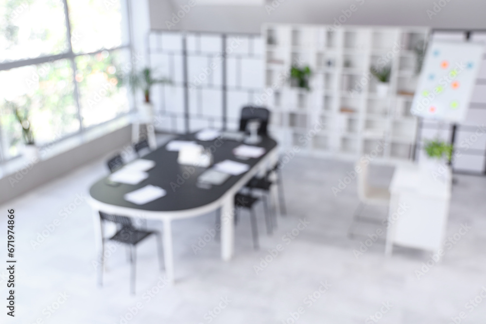 Blurred view of conference hall with table in office