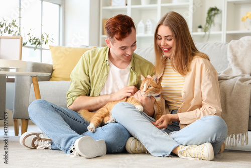Young couple with cute cat ...