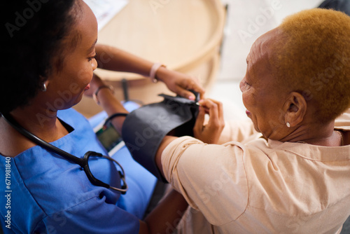 Obraz na płótnie Senior woman, nurse and check blood pressure, caregiver and wellness, health and medicine at nursing home