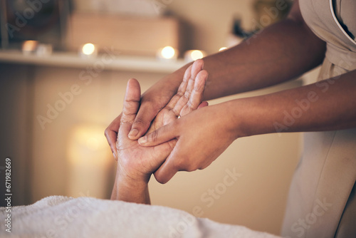 Woman, hands and massage in relax for spa treatment, body care or physical therapy at the resort. Closeup of female person holding hand for stress relief, comfort or zen in healing or reiki at salon
