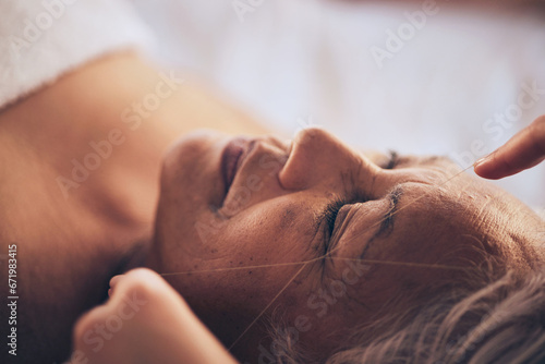 Senior woman, hands and string for grooming, hair removal or threading at beauty salon, spa or hotel resort. Closeup of female person sleeping in relax or zen for facial treatment or physical therapy
