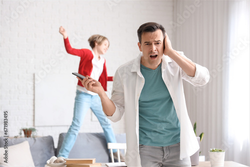 Stressed father holding pho...