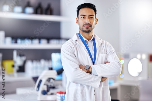 Scientist, man and arms crossed in portrait, science study for medical research in laboratory with confidence. Biotechnology, serious male doctor and scientific experiment, future and investigation photo