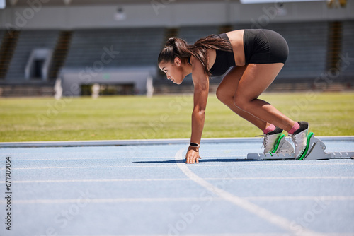 Running, sports and fitness with an asian woman athlete on a track for a race, marathon or endurance training. Health, workout and exercise with a female runner at the start of a competitive sport