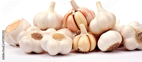 Garlic bulbs with individual cloves separated and placed on a white background