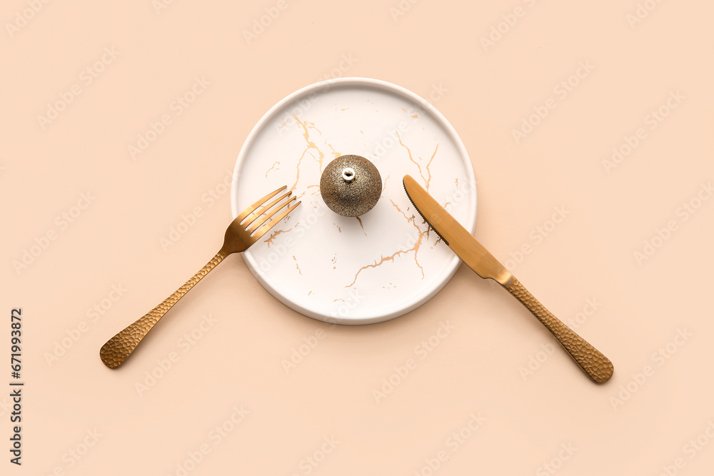 Beautiful table setting with Christmas ball on beige background Beautiful table setting with Christmas ball on beige background