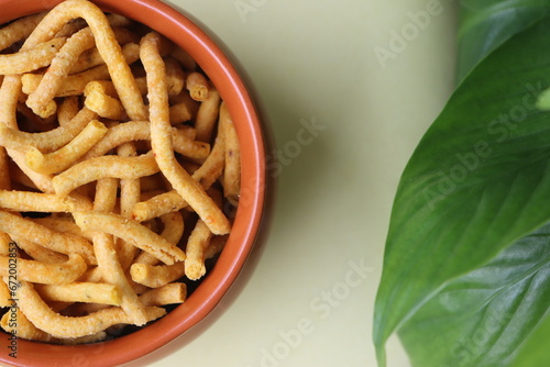 Namkeen, thick sev, Indian popular snack, festival food, food consisting of small pieces of crunchy noodles made from chickpea flour, which are seasoned with spices and herbs photo