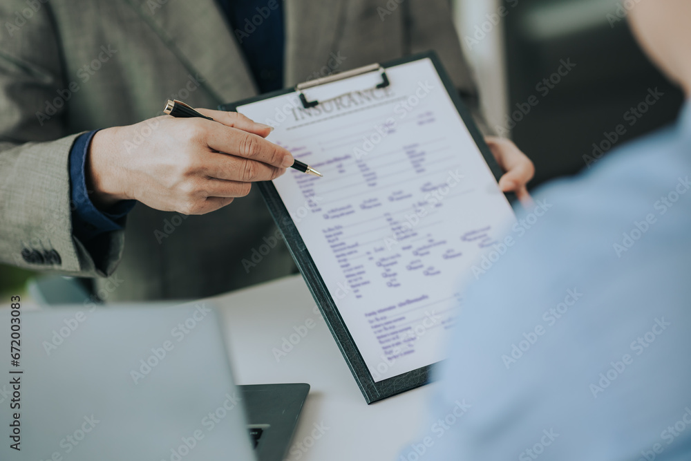 Close-up photo of a real estate agent offering a contract to purchase or rent a residence. Businessman holds small house model with property insurance at table in home sales office Close-up photo of a real estate agent offering a contract to purchase or rent a residence. Businessman holds small house model with property insurance at table in home sales office