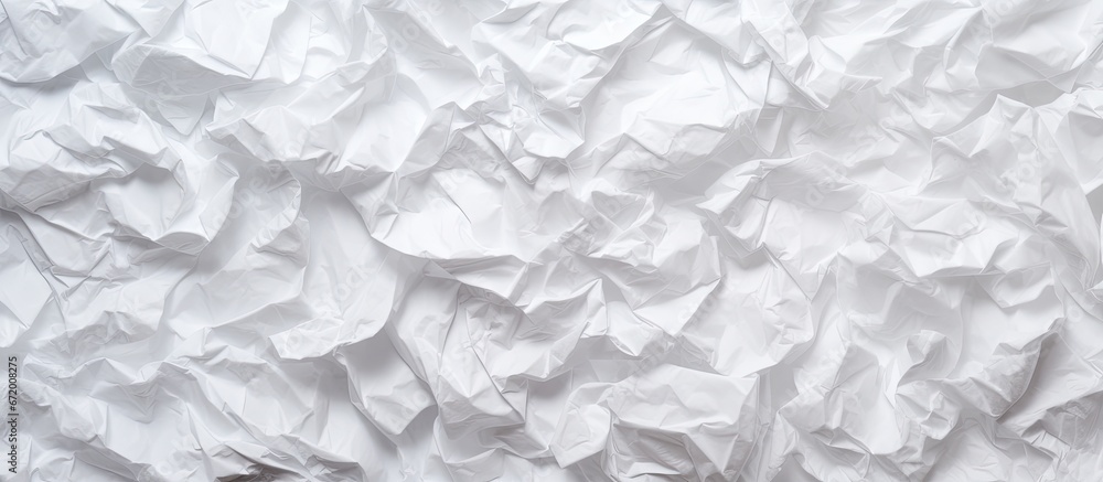 Obraz premium A top view of a textured background made of crumpled white paper