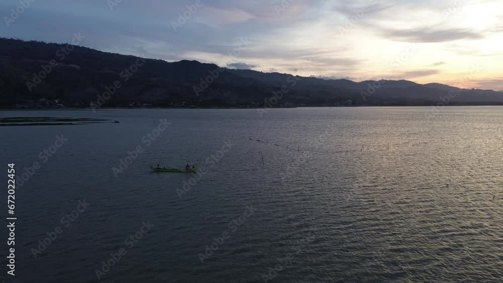 aerial view of a fisherman on his boat in the lake aerial view of a fisherman on his boat in the lake