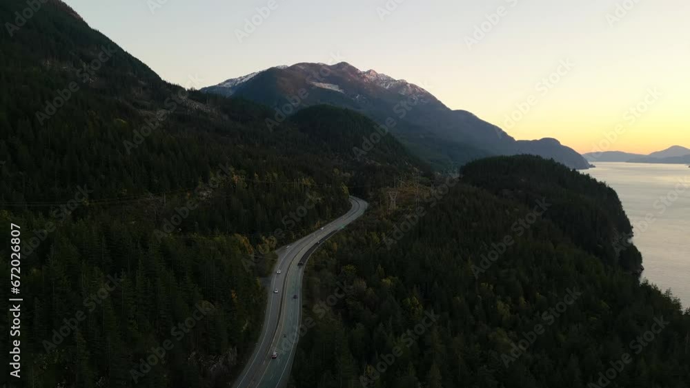 Sea to Sky Highway on West Coast of Pacific Ocean. Aerial Mountain Landscape. Twilight sky. Howe Sound, BC, Canada.