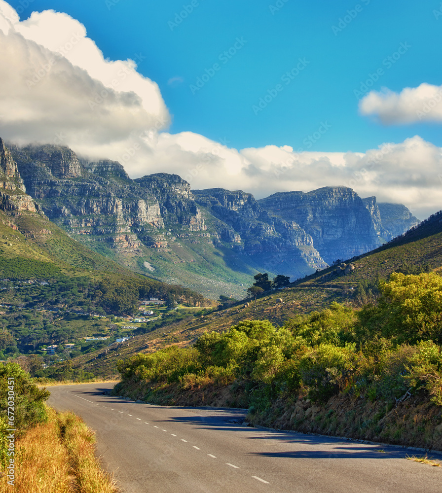 Fototapeta premium Copy space with a mountain pass along the Twelve Apostles in Cape Town, South Africa against a cloudy sky background over a peninsula. Calm and scenic landscape to travel or explore on a road trip