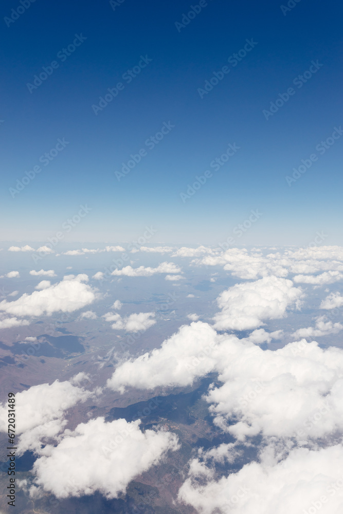 Beautiful view from the airplane window from above to the clouds, mountains, roads, rivers. Picturesque landscape from a helicopter window on a sunny day. Beautiful view from the airplane window from above to the clouds, mountains, roads, rivers. Picturesque landscape from a helicopter window on a sunny day.