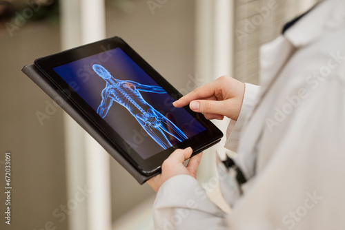 Doctor, hands and tablet x ray, mri results and healthcare research, anatomy solution and injury review of skeleton. Medical professional or radiology person with xray graphic on digital screen photo