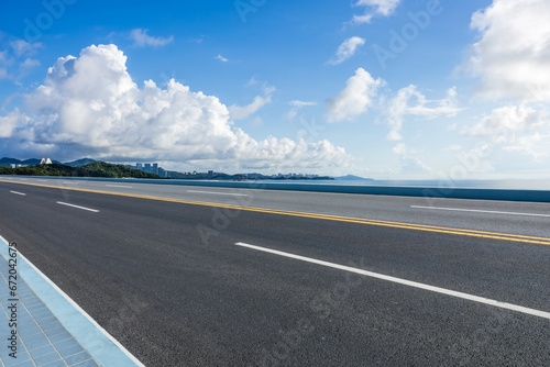 Asphalt highway road and coastline landscape under blue sky © ABCDstock