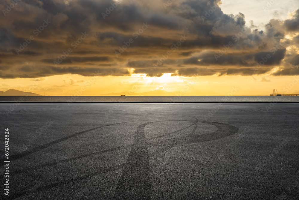 Fototapeta premium Asphalt road and coastline nature landscape at sunrise