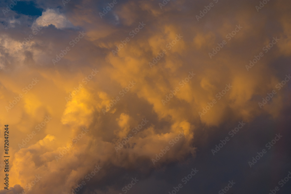 Orange stratus clouds shining above the beach and the horizon