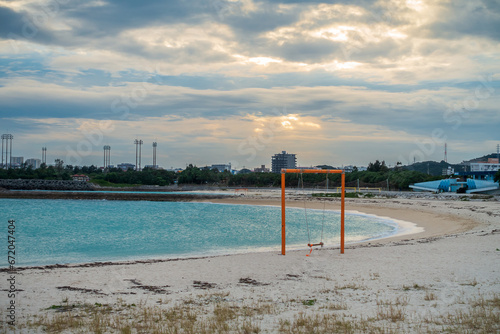 At dusk, a swing stands on the seaside of Nishihara Marine Park,Okinawa,Japan