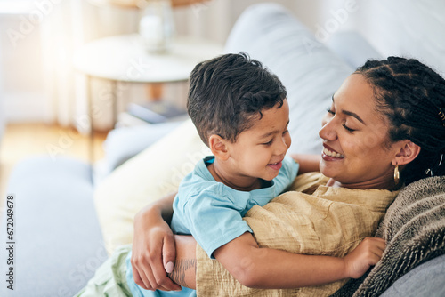 Smile hug and happy family mom, kid and home bonding for child security, support or care on lounge couch. Hugging, playing and excited mama, mum or woman laugh with young child in relax quality time